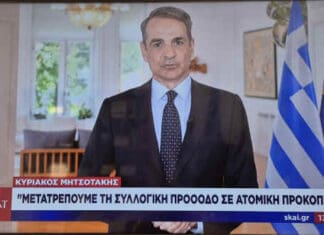 Εσύ θα πάρεις καθρεφτάκια από τα κλεμμένα ? Άνδρας σε επίσημη συνέντευξη με ελληνική σημαία και ευρωπαϊκή σημαία στο background.