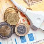 ΑΚΡΙΒΕΙΑ ΣΟΚ ΚΑΙ ΜΙΣΘΟΙ ΠΕΙΝΑΣ: Η ΚΥΒΕΡΝΗΣΗ ΑΡΝΕΙΤΑΙ ΝΑ ΔΕΙ ΤΗΝ ΠΡΑΓΜΑΤΙΚΟΤΗΤΑ! Εικόνα με νομίσματα ευρώ και ηλεκτρική πρίζα, συμβολίζοντας την οικονομική και ενεργειακή βιωσιμότητα, ενισχύοντας την κουλτούρα της κυκλικής δημοκρατίας.